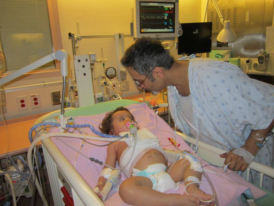 Baby Lillian with her father in the hospital