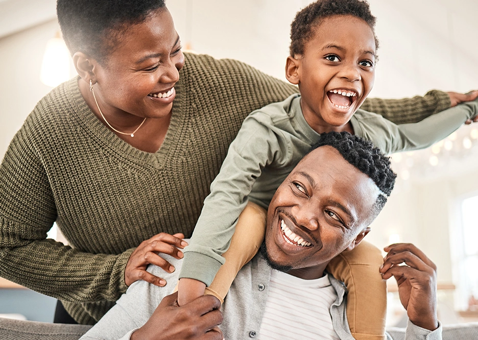 Happy mother and father playing with their son